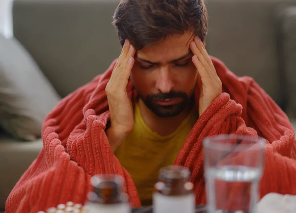 Man experiencing a severe migraine headache, illustrating symptoms relevant to VA migraine disability claims.